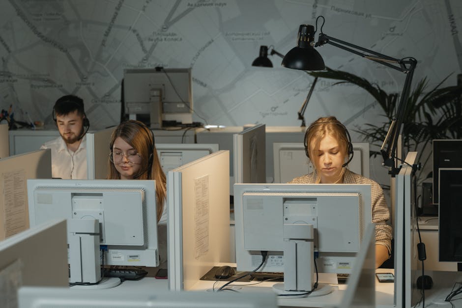 Office workers at computers in a modern BPO workplace